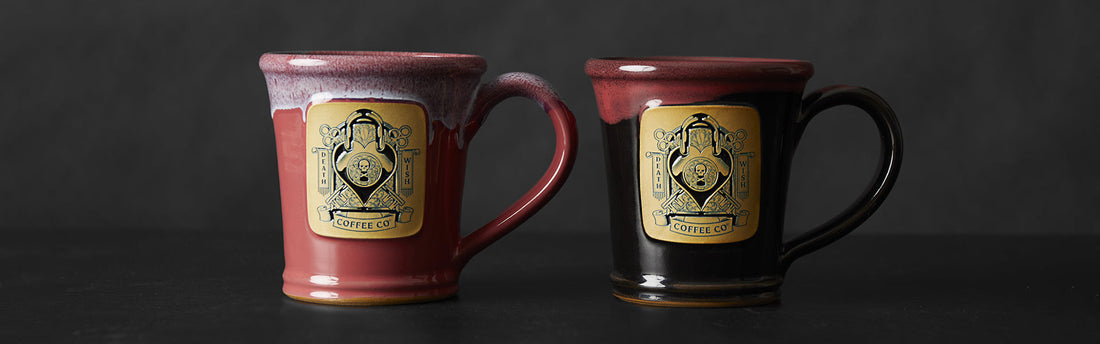 The regular release of the Lock and Key Mug on the left next to the Golden Ticket Lock and Key Mug on the right.