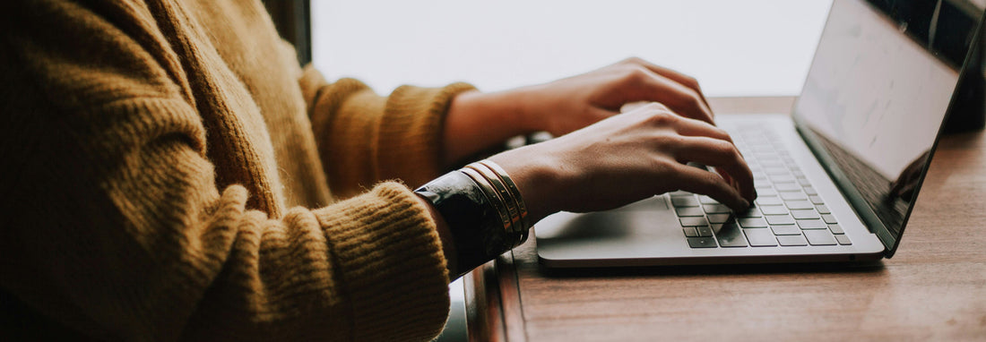 A woman typing an email to her boss to make her own sick day for the Leap Year.