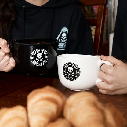 Two people drinking coffee from the Soul Mugs Set.