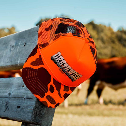 The Death Wish Coffee Hardly Hidden Trucker Hat Sitting on a Fence Post.