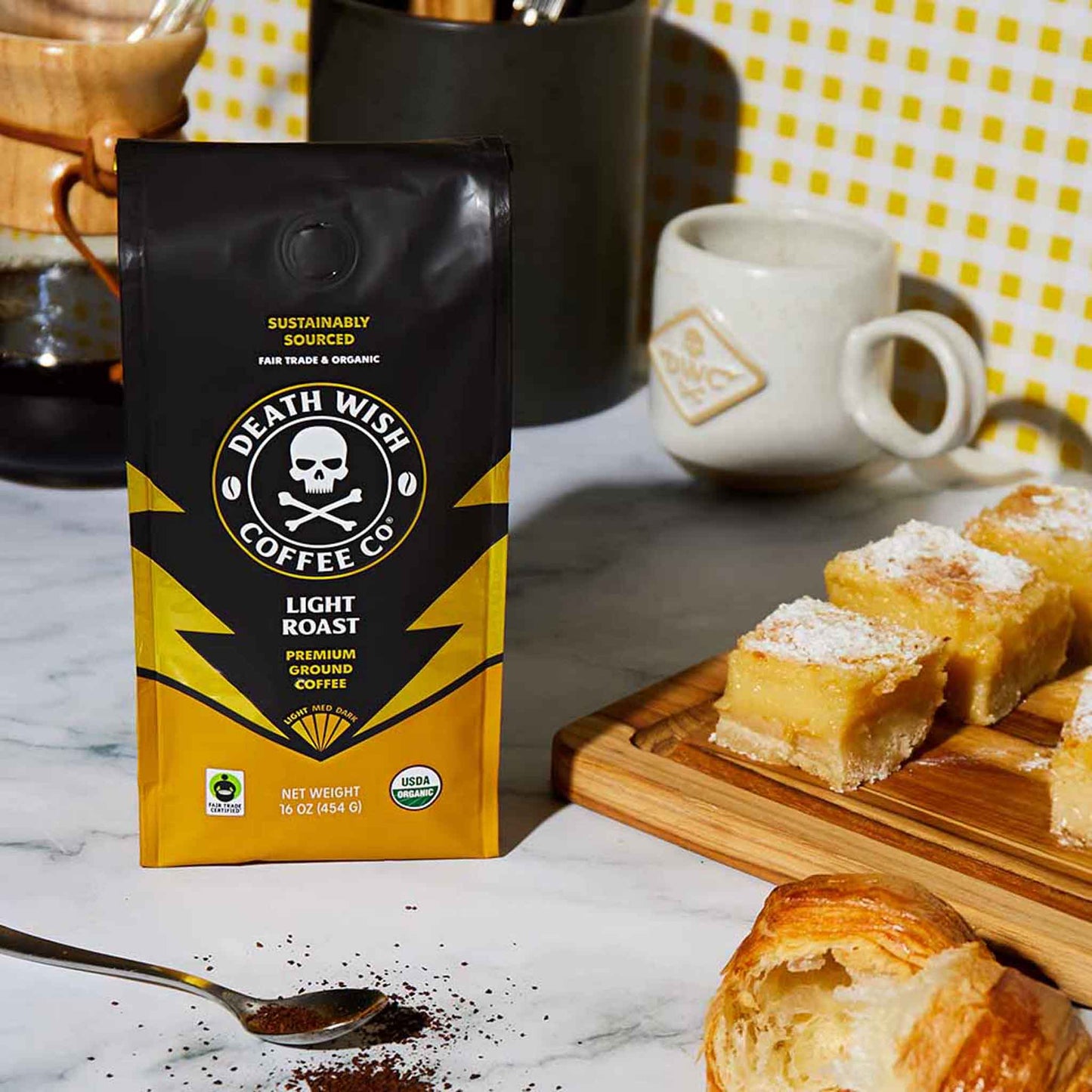 A bag of Light Roast Death Wish Coffee next to freshly made baked goods.