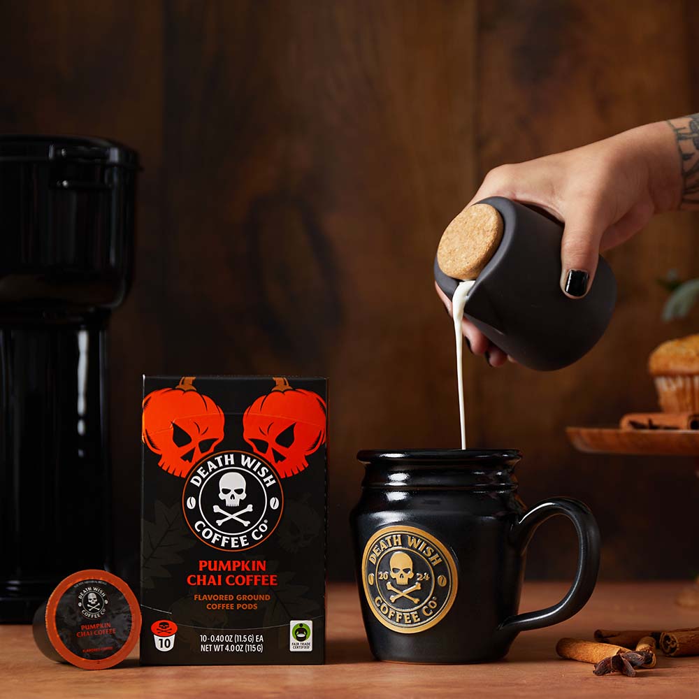 Pouring creamer into Death Wish Coffee Pumpkin Chai Flavored Coffee made with Single-Serve Pods