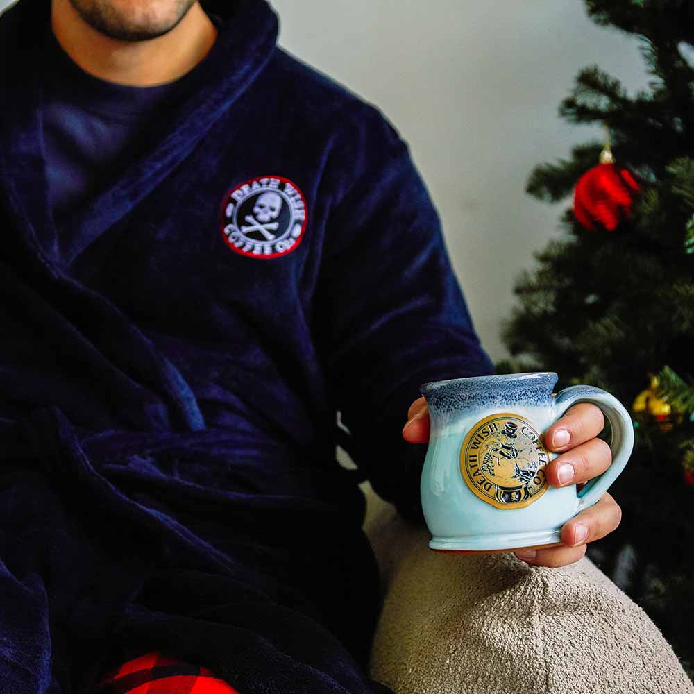 A man holding the Death Wish Coffee Frostbite Mug.