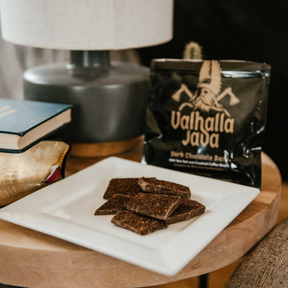 A bag of Death Wish Coffee Valhalla Java Dark Chocolate Bark with pieces on a plate.